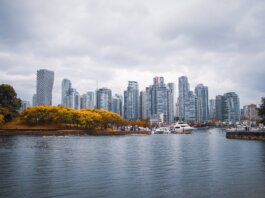 Captivating view of Vancouver skyline during autumn, showcasing skyscrapers and waterfront reflections.