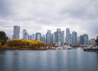 Captivating view of Vancouver skyline during autumn, showcasing skyscrapers and waterfront reflections.