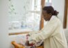 A nurse tending to a newborn in a hospital nursery, showing care and compassion.