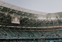 A spacious, modern sports stadium in Kocaeli, Türkiye, illuminated during sunset.