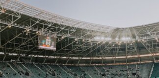 A spacious, modern sports stadium in Kocaeli, Türkiye, illuminated during sunset.
