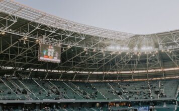 A spacious, modern sports stadium in Kocaeli, Türkiye, illuminated during sunset.