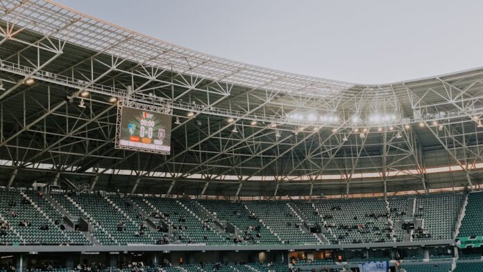 A spacious, modern sports stadium in Kocaeli, Türkiye, illuminated during sunset.