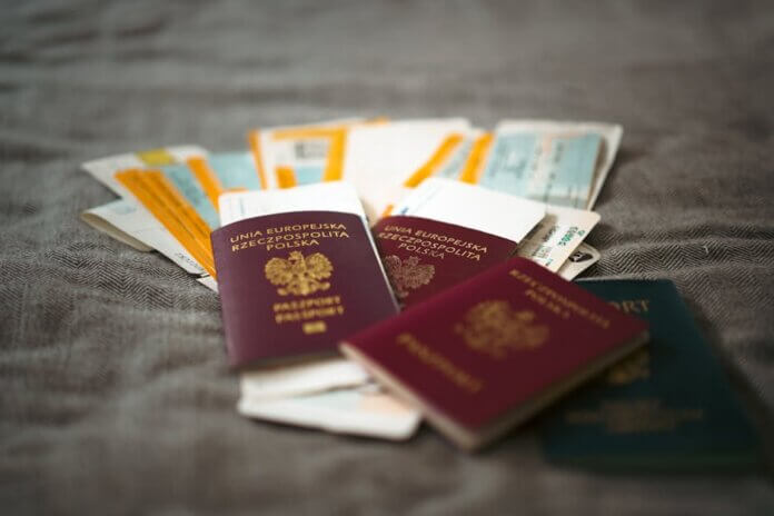 Close-up of Polish passports and travel tickets symbolizing travel and adventure. Close-up of Polish passports and travel tickets symbolizing travel and adventure.