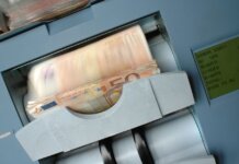 50 Euro banknotes being processed in a high-speed counting machine, showcasing technology and finance in action.