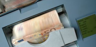 50 Euro banknotes being processed in a high-speed counting machine, showcasing technology and finance in action.