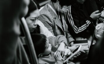 A candid black and white photo capturing a family scene in a Nanjing subway.