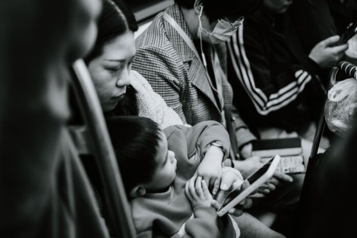 A candid black and white photo capturing a family scene in a Nanjing subway.