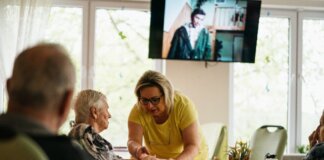 A caregiver assists a senior adult in a Karviná retirement home.
