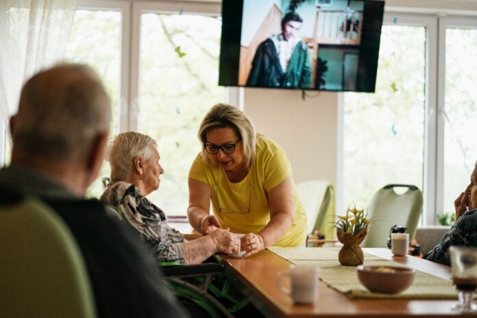 A caregiver assists a senior adult in a Karviná retirement home. A caregiver assists a senior adult in a Karviná retirement home.