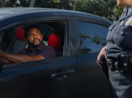 A driver receives a traffic ticket from a police officer for a speeding violation.