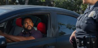 A driver receives a traffic ticket from a police officer for a speeding violation.