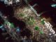 A lively aerial view of a crowded nighttime street festival with illuminated streets.
