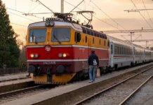 A passenger boards a vintage train at sunset in Kutina, Croatia. Scenic travel moment.