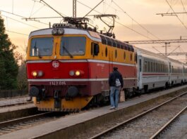 A passenger boards a vintage train at sunset in Kutina, Croatia. Scenic travel moment.