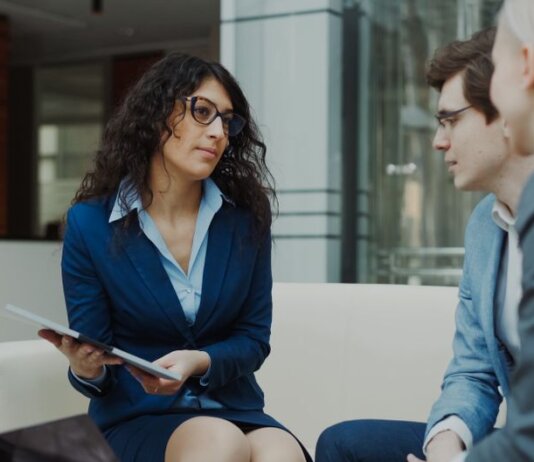 A professional meeting with a team discussing business strategies in a modern office setting.