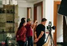A professional photography crew working inside a studio with camera equipment.