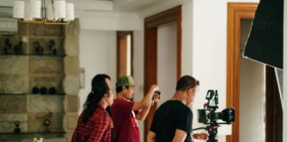 A professional photography crew working inside a studio with camera equipment.