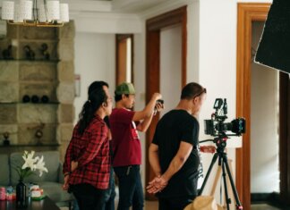 A professional photography crew working inside a studio with camera equipment.