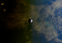 A satellite orbiting Earth showcasing contrasts between ocean and land from space.