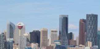 A stunning view of Calgary's skyline featuring the iconic Calgary Tower against a clear sky.