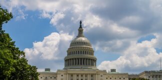 A stunning view of the iconic United States Capitol under a blue sky in Washington, D.C.