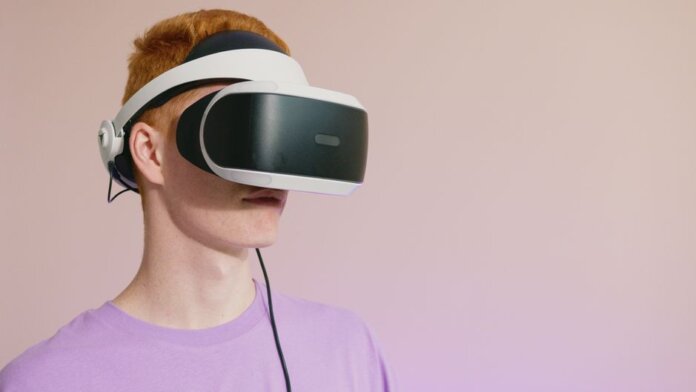 A young caucasian man wearing VR glasses, experiencing virtual reality. A young caucasian man wearing VR glasses, experiencing virtual reality.