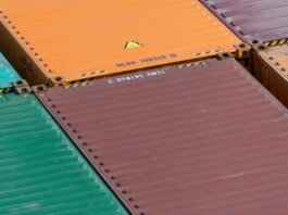 Aerial view of vibrant cargo containers arranged in a pattern, emphasizing logistics and transportation.