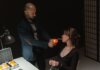 An intense scene depicting a suspect lighting a cigarette during an interrogation.