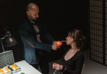 An intense scene depicting a suspect lighting a cigarette during an interrogation.