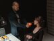 An intense scene depicting a suspect lighting a cigarette during an interrogation.