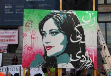 Artistic protest sign highlighting women's rights at a Vancouver demonstration.