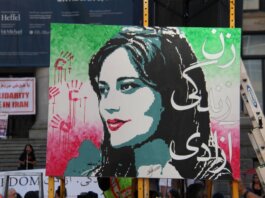 Artistic protest sign highlighting women's rights at a Vancouver demonstration.