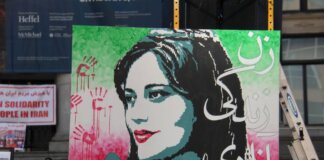 Artistic protest sign highlighting women's rights at a Vancouver demonstration.