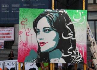 Artistic protest sign highlighting women's rights at a Vancouver demonstration.