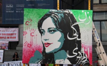 Artistic protest sign highlighting women's rights at a Vancouver demonstration.