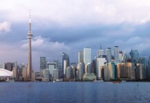 Beautiful view of Toronto skyline with the iconic CN Tower during sunset, showcasing urban architecture.