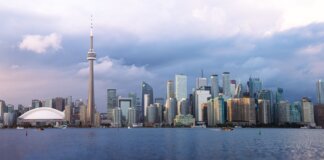 Beautiful view of Toronto skyline with the iconic CN Tower during sunset, showcasing urban architecture.