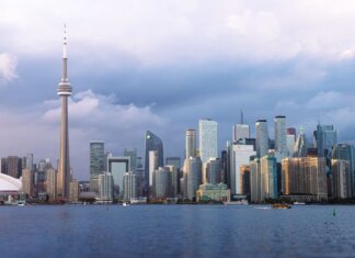 Beautiful view of Toronto skyline with the iconic CN Tower during sunset, showcasing urban architecture.