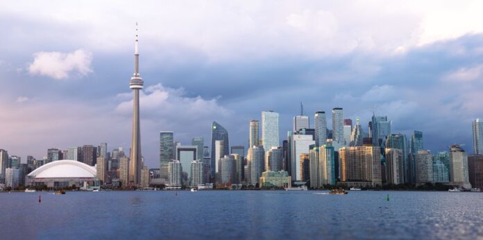 Beautiful view of Toronto skyline with the iconic CN Tower during sunset, showcasing urban architecture. Beautiful view of Toronto skyline with the iconic CN Tower during sunset, showcasing urban architecture.