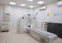 Bright and sterile hospital imaging room featuring a state-of-the-art CT scanner.