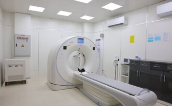 Bright and sterile hospital imaging room featuring a state-of-the-art CT scanner.