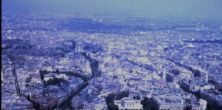 Captivating aerial view of the sprawling cityscape of Paris with iconic landmarks visible.