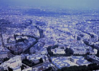 Captivating aerial view of the sprawling cityscape of Paris with iconic landmarks visible.