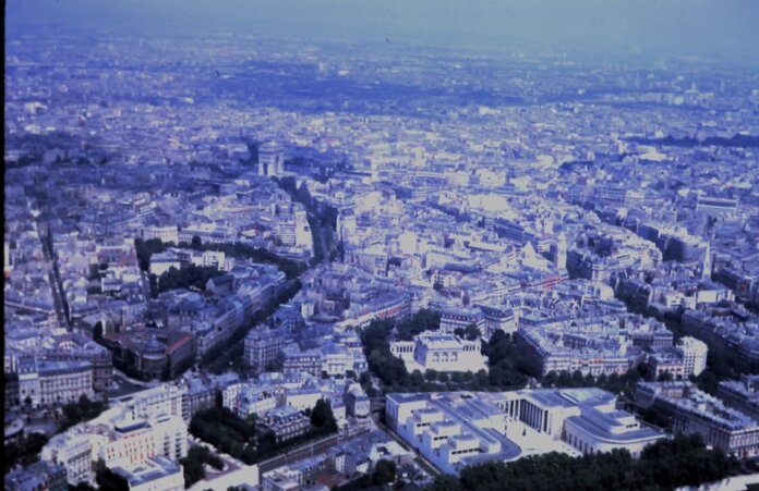 Captivating aerial view of the sprawling cityscape of Paris with iconic landmarks visible.