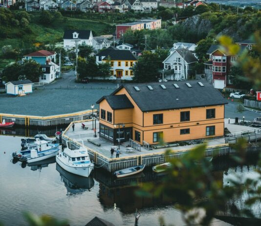 Charming aerial view of Quidi Vidi village and harbor with boats and colorful houses in St. John's, Newfoundland.