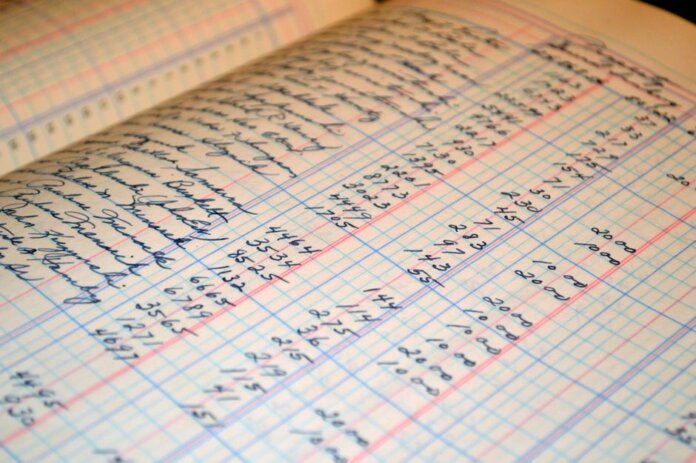 Close-up of a vintage handwritten ledger detailing financial records and accounts. Close-up of a vintage handwritten ledger detailing financial records and accounts.