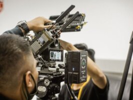 Close-up of advanced filmmaking equipment being used by professionals indoors.