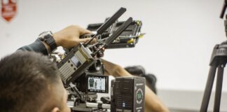 Close-up of advanced filmmaking equipment being used by professionals indoors.