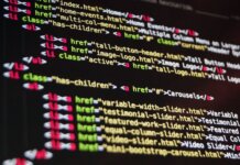 Close-up of HTML code highlighted in vibrant colors on a computer monitor.